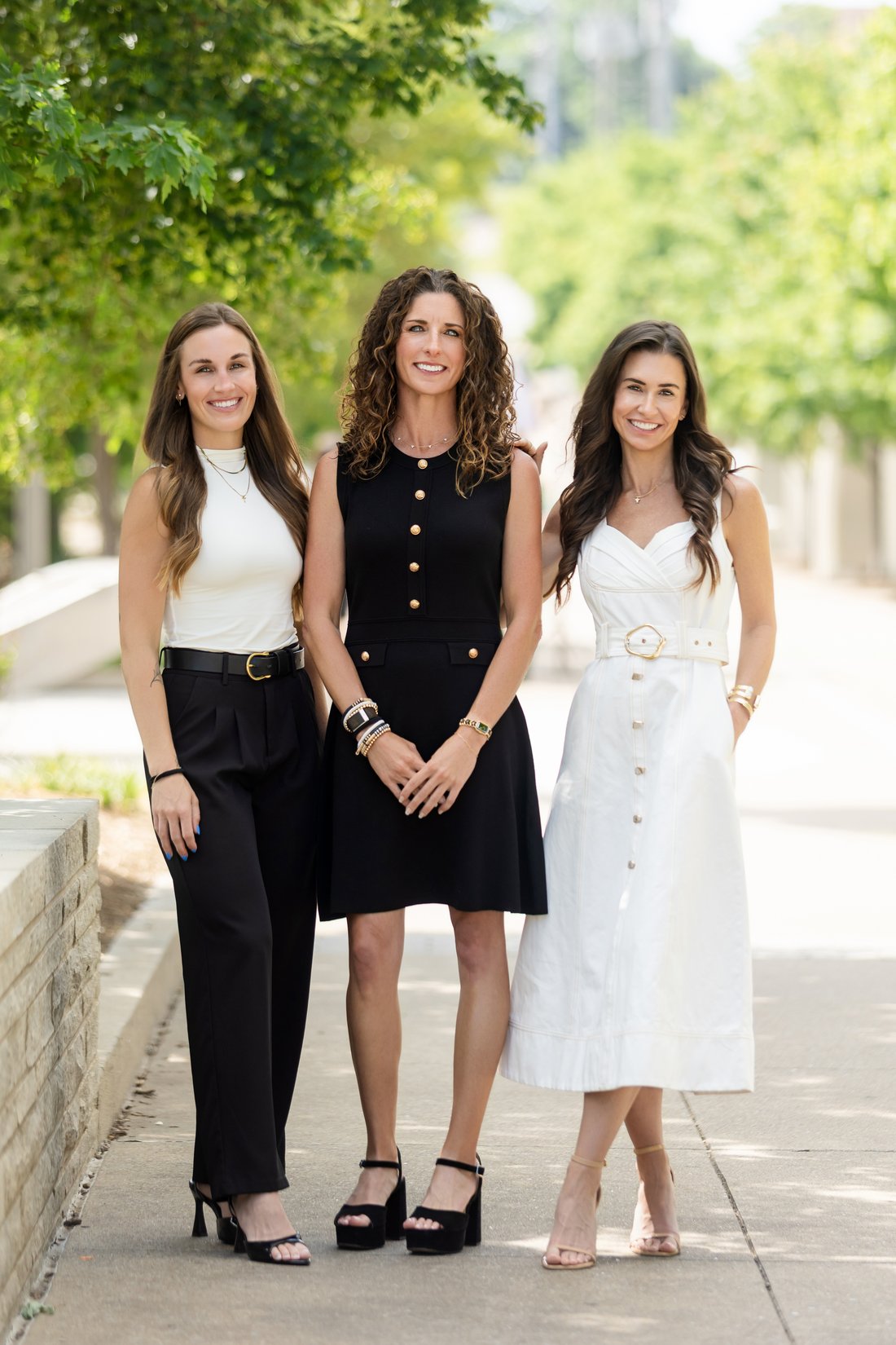 Three colleagues photographed together outdoors