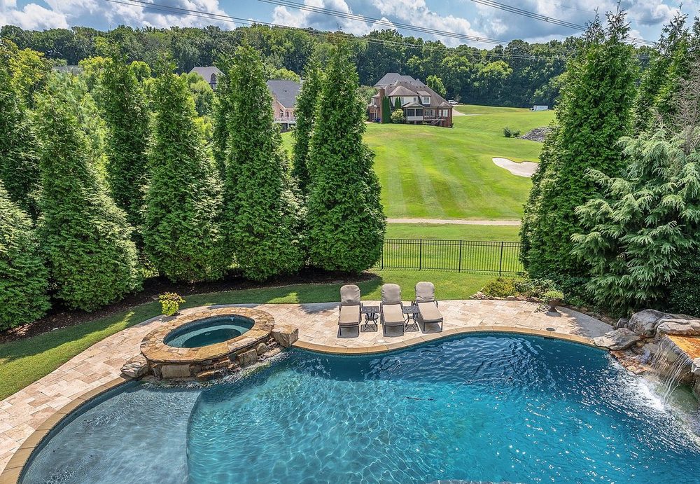 Aerial of the pool and spa looking out to a golf fairway
