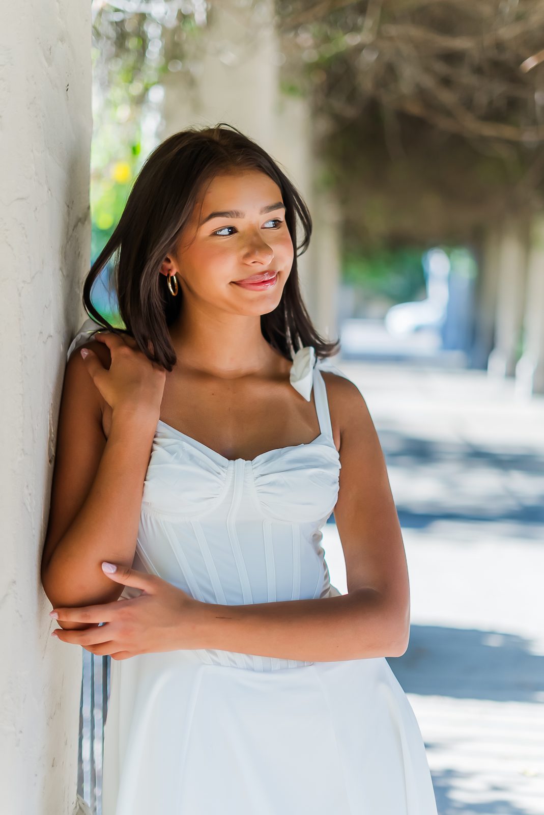 A senior portrait in soft shade, the subject looking off camera